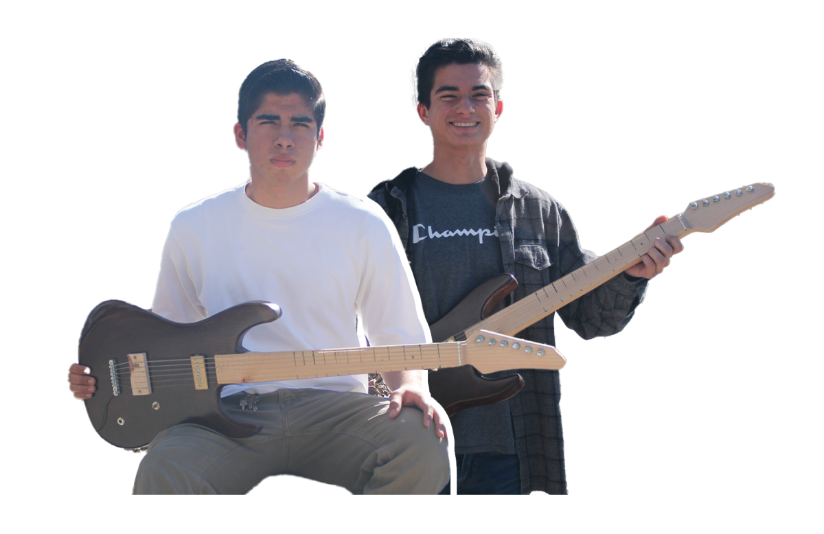 Sophomore Samuel Lepe and junior Armand Marquez take turns displaying their one freshly crafted electric guitar. “The best part of building a guitar is the moment you string it up and hear it play for the first time. It makes all the effort worth it,” Lepe said. 